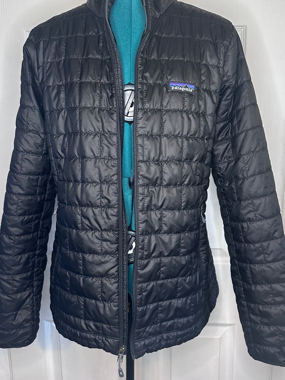 Patagonia Women's Black Quilted Puffer Jacket with Vail logo on sleeve.